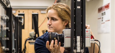 Woman adjusting camera