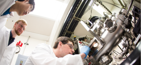 Students in lab looking at equipment