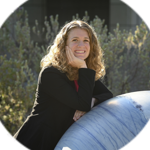 Sonia Martin posting outside alongside one of the engineering quad's marble spheres.